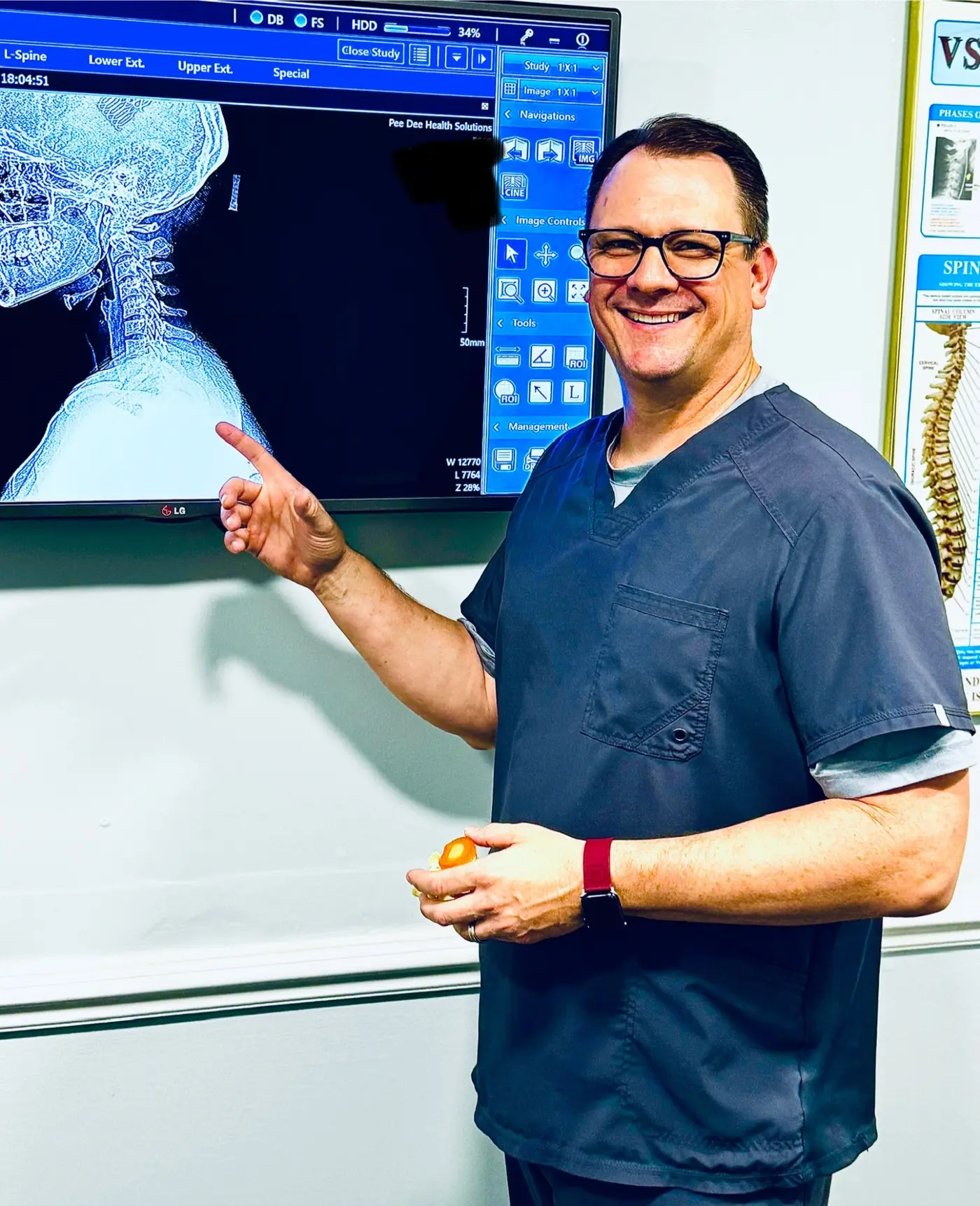 Dr. John Bracey discussing a cervical spine x-ray in the clinic